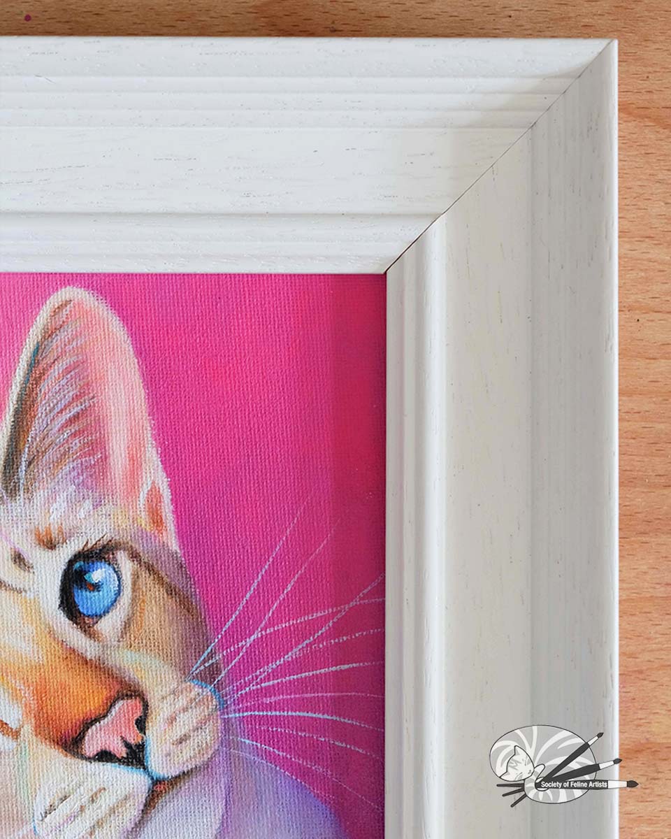 Close up details of the frame on an oil painting of a siamese cat with blue eyes on a pink background