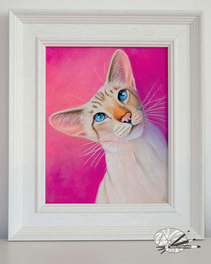 Framed painting of a siamese cat with blue eyes on a pink background in a white wood frame
